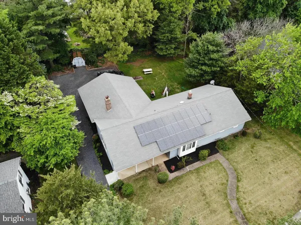 an aerial view of a house with garden space and street view