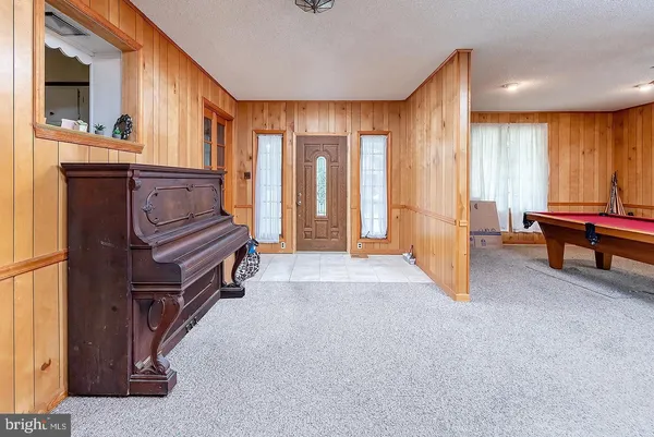 a view of an empty room with a fireplace and a window
