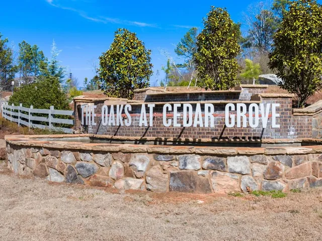 a view of a house with wooden deck and a yard