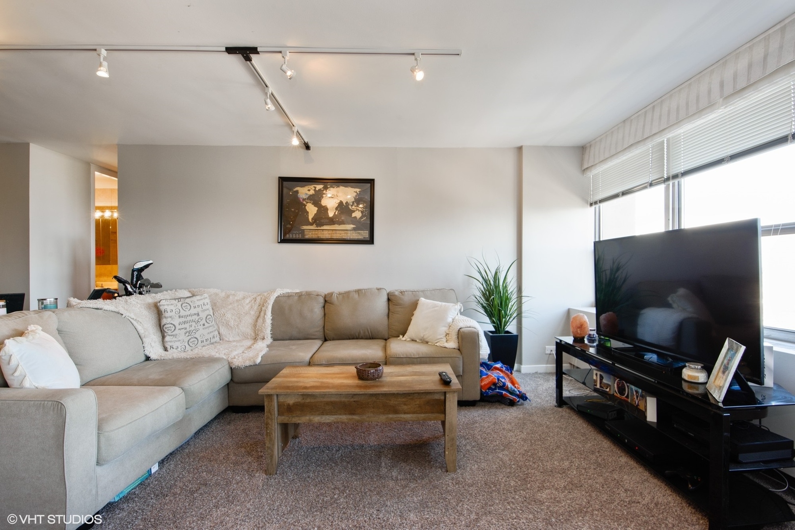 655 West Irving Park Road, Unit 1614 Chicago, IL 60613 - Photo 2 of 22 a living room with furniture and a flat screen tv