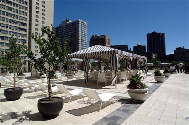 655 West Irving Park Road, Unit 1614 Chicago, IL 60613 - Photo 18 of 22 a view of a patio with chairs and potted plants