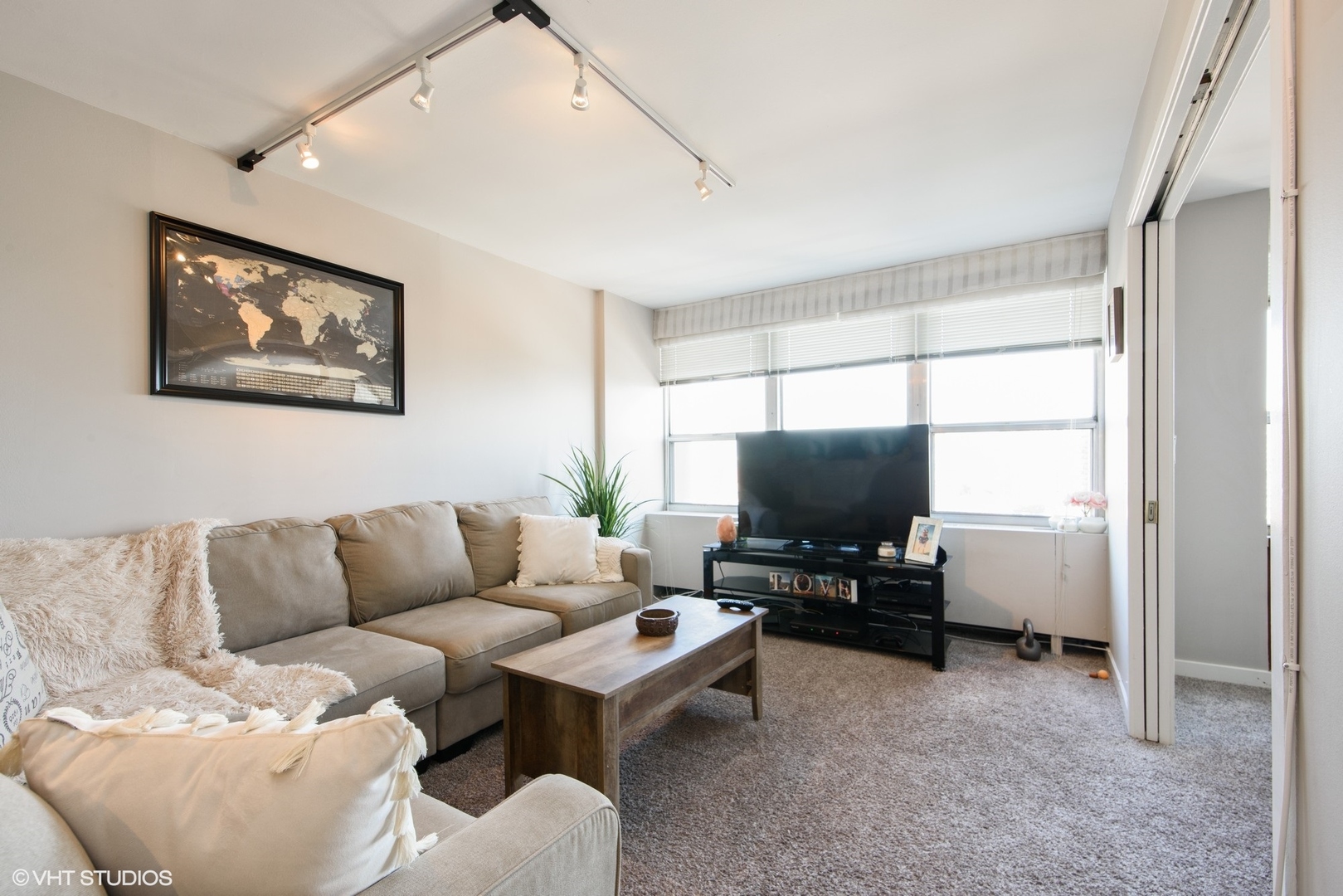 655 West Irving Park Road, Unit 1614 Chicago, IL 60613 - Photo 3 of 22 a living room with furniture and a flat screen tv