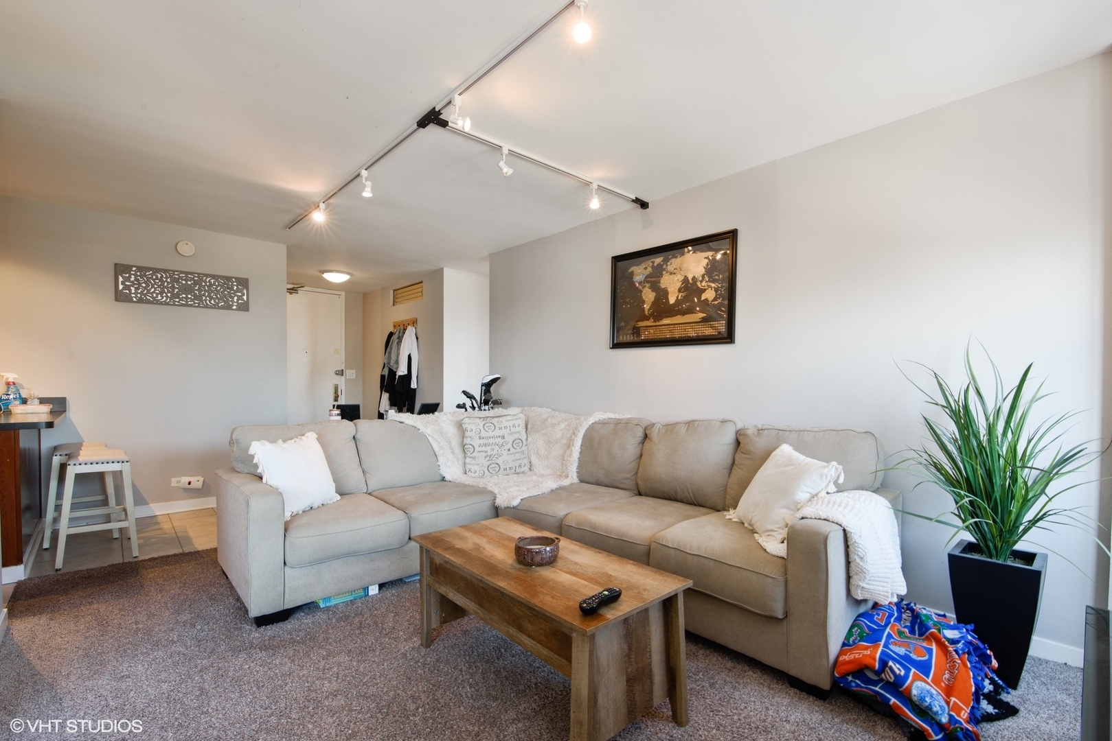655 West Irving Park Road, Unit 1614 Chicago, IL 60613 - Photo 4 of 22 a living room with furniture a couch and a potted plant