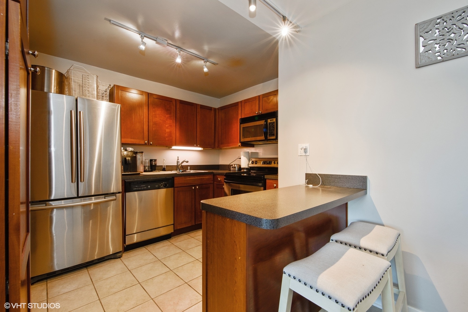 655 West Irving Park Road, Unit 1614 Chicago, IL 60613 - Photo 5 of 22 a kitchen with granite countertop a sink appliances and cabinets