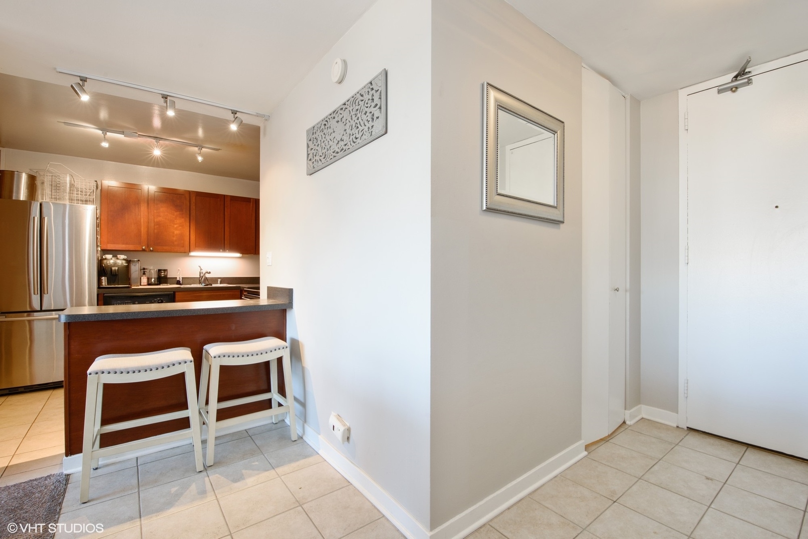 655 West Irving Park Road, Unit 1614 Chicago, IL 60613 - Photo 8 of 22 a room with stainless steel appliances a refrigerator and cabinets