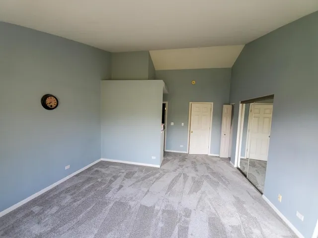 a view of a big room with closet and windows