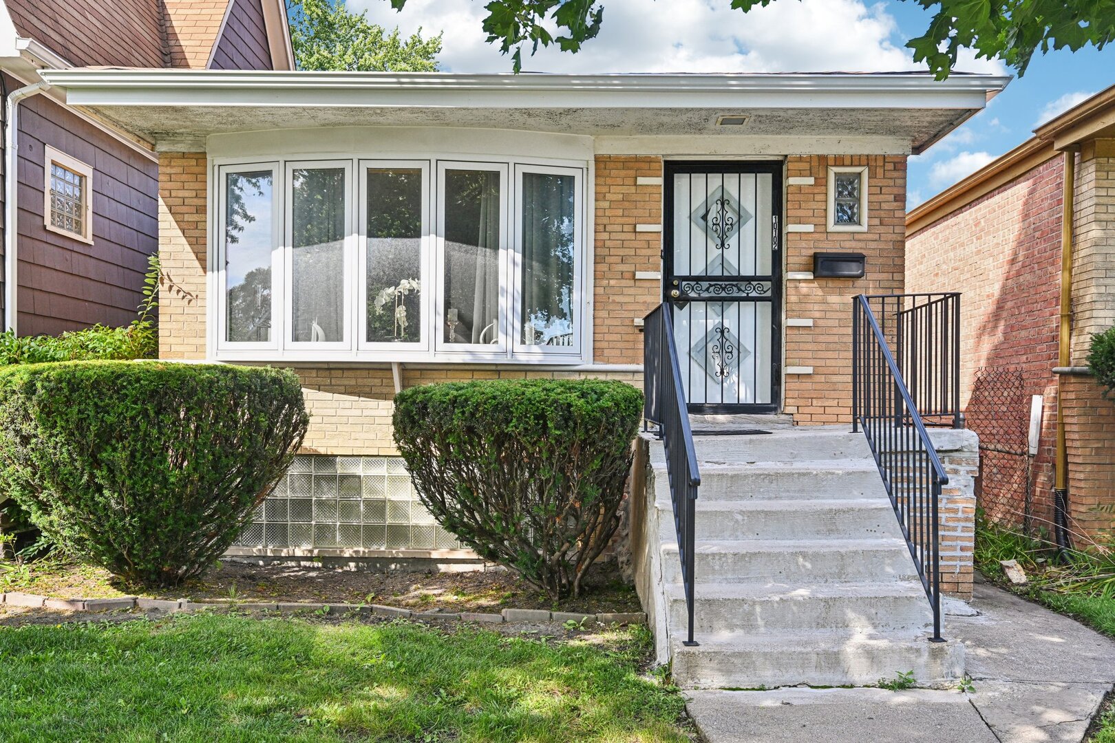 10102 S Lane Chicago, IL 60628 - Photo 1 of 15 a view of a house with many windows and plants