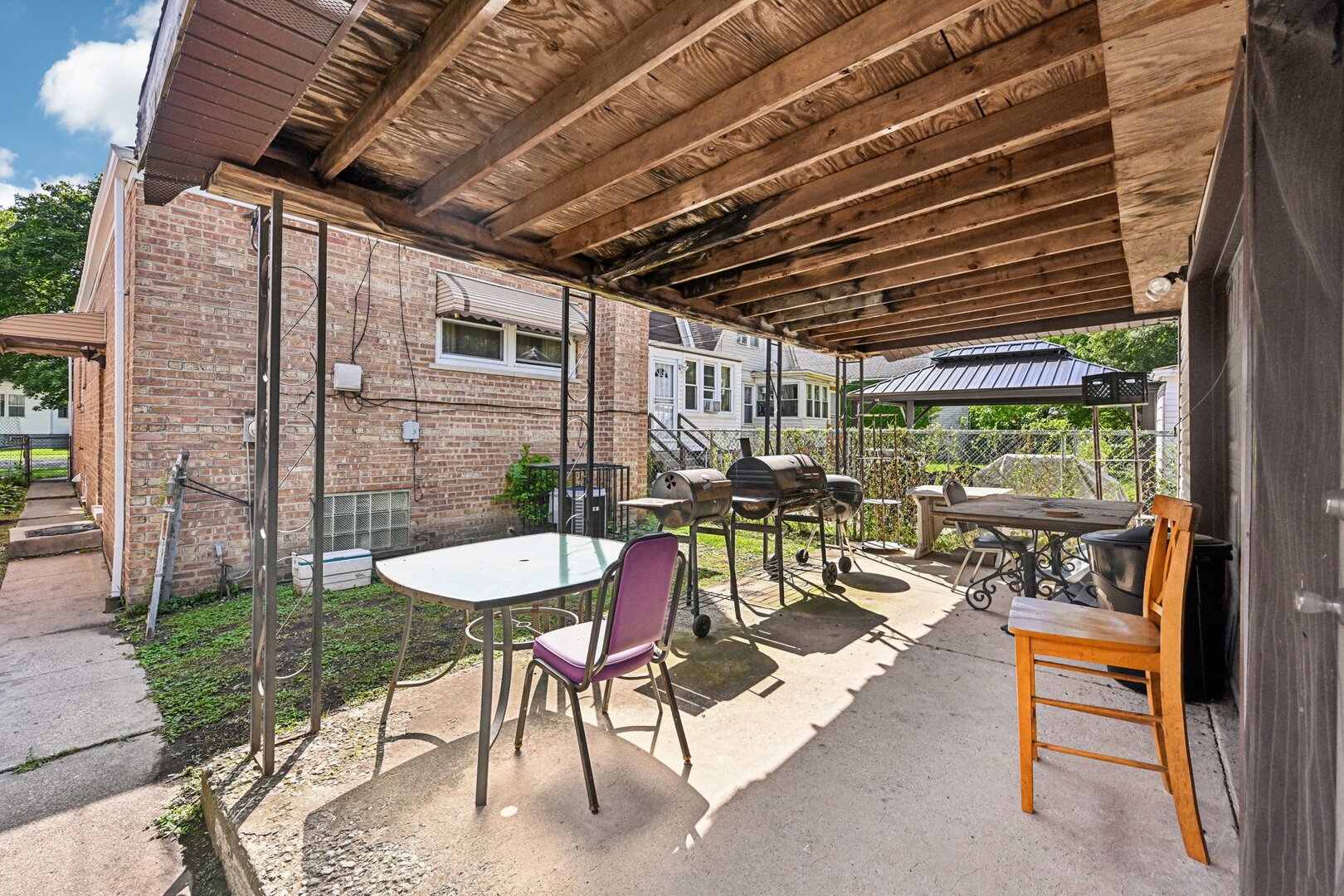 10102 S Lane Chicago, IL 60628 - Photo 14 of 15 a view of a patio with a table chairs and a couple of flower plants