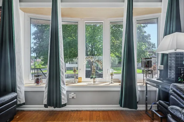 a view of living room with a floor to ceiling window and wooden floor