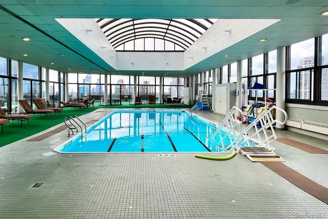 a view of swimming pool with seating area