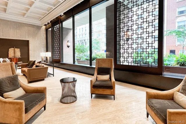 a living room with furniture and a floor to ceiling window