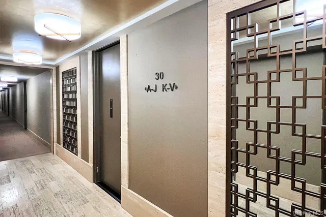 a view of a hallway with a bathroom