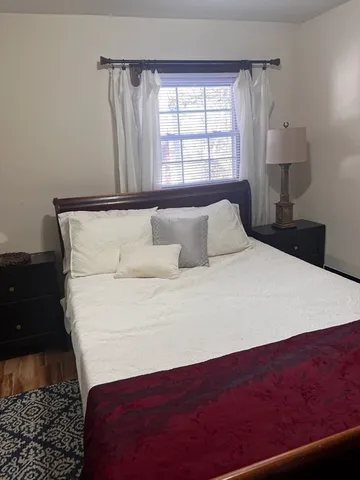 a bedroom with a bed and a window