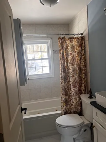 a bathroom with a toilet and a shower