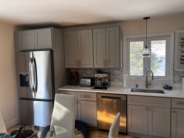 a kitchen with stainless steel appliances a refrigerator sink and cabinets