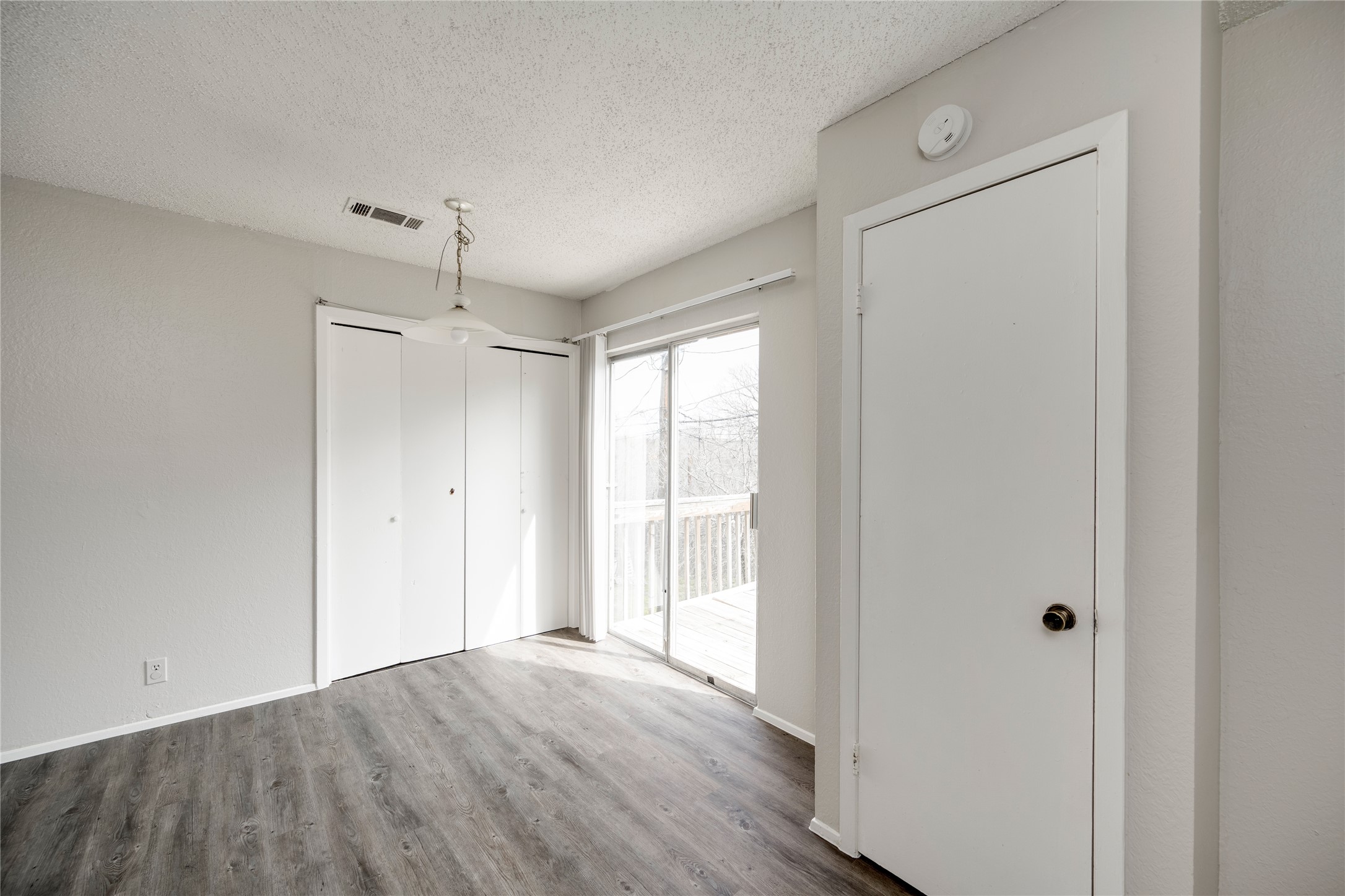 11907 Alpheus Avenue, Unit D Austin, TX 78759 - Photo 12 of 26 a view of empty room with wooden floor and window