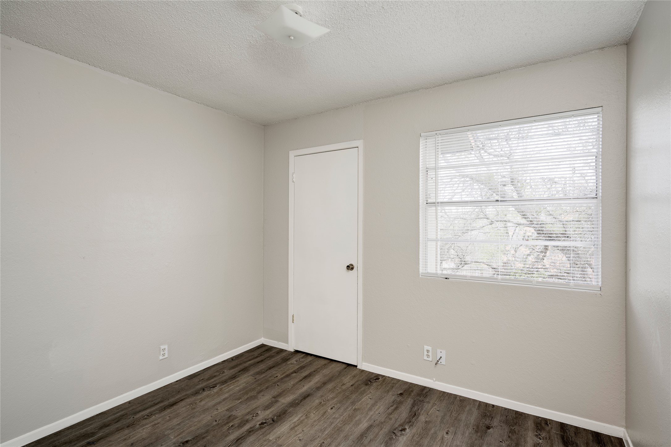 11907 Alpheus Avenue, Unit D Austin, TX 78759 - Photo 17 of 26 an empty room with wooden floor and windows