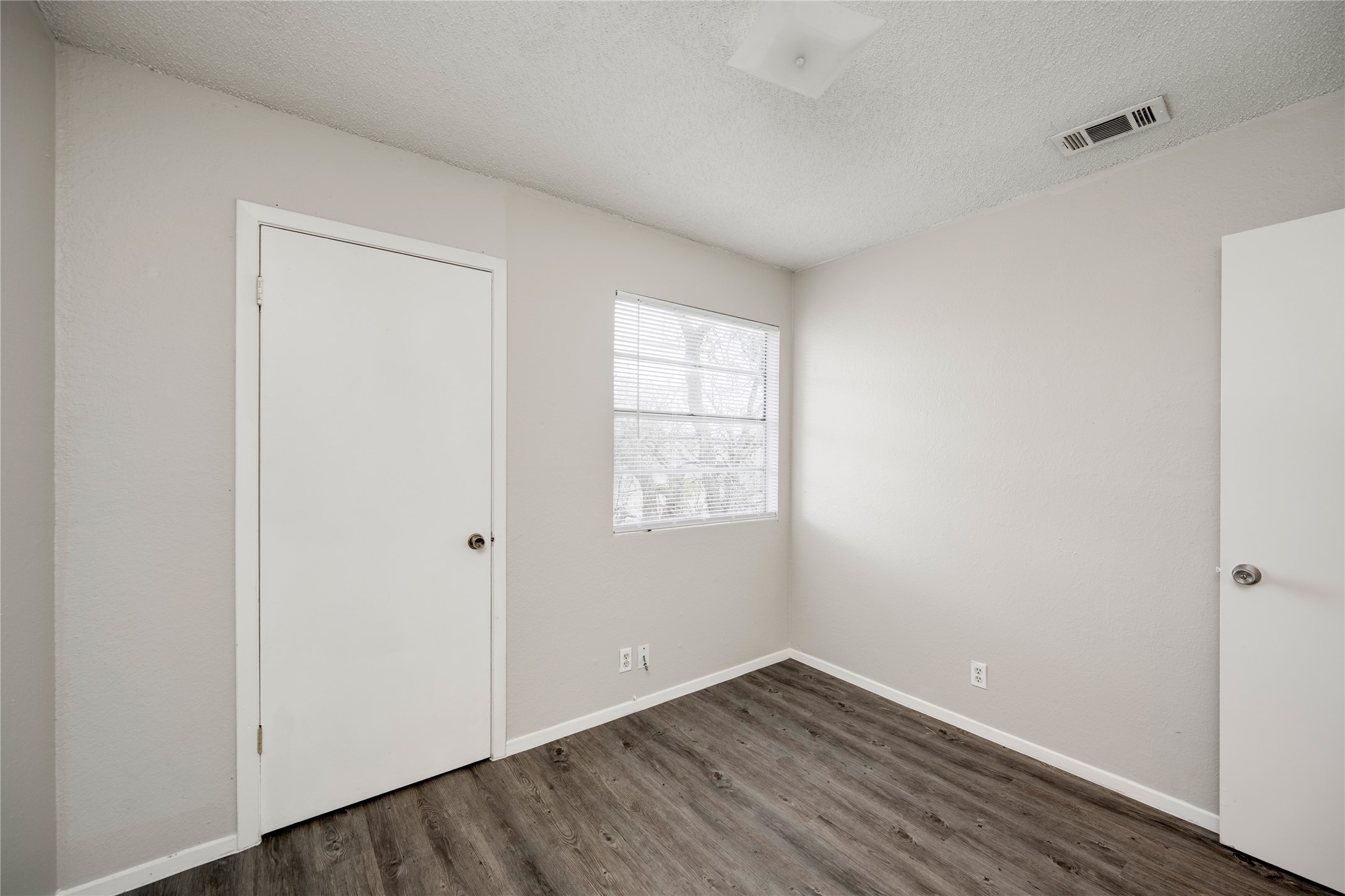 11907 Alpheus Avenue, Unit D Austin, TX 78759 - Photo 18 of 26 a view of an empty room with wooden floor and a window
