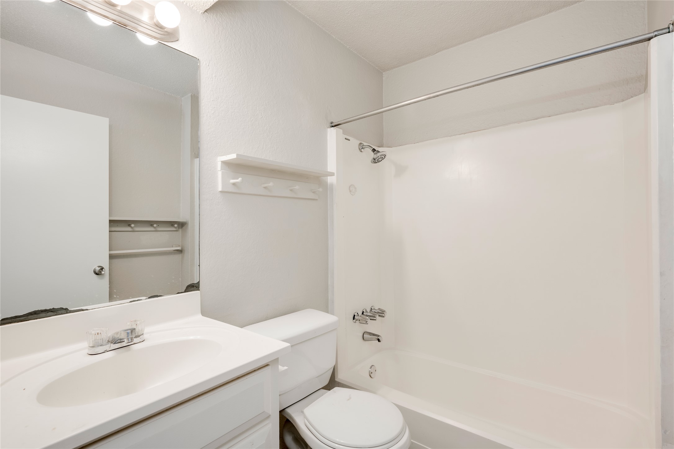 11907 Alpheus Avenue, Unit D Austin, TX 78759 - Photo 20 of 26 a bathroom with a sink toilet and shower