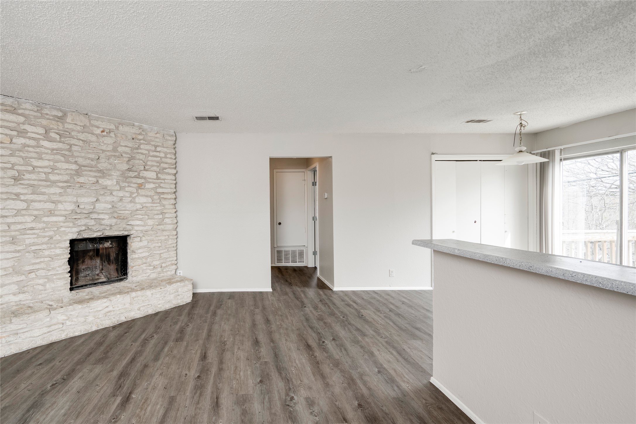 11907 Alpheus Avenue, Unit D Austin, TX 78759 - Photo 2 of 26 a view of empty room with wooden floor and fireplace