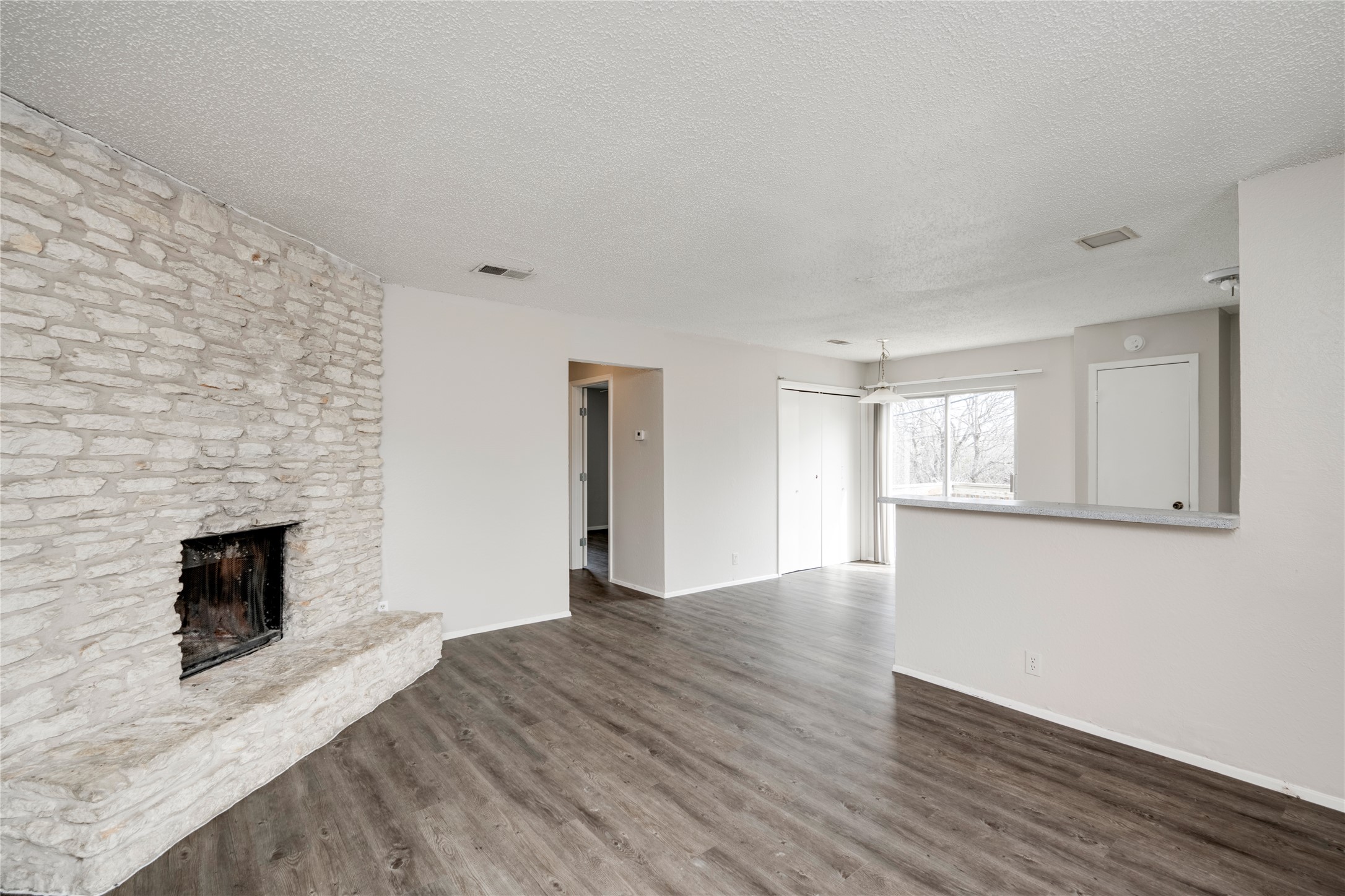 11907 Alpheus Avenue, Unit D Austin, TX 78759 - Photo 3 of 26 a view of empty room with wooden floor and fireplace