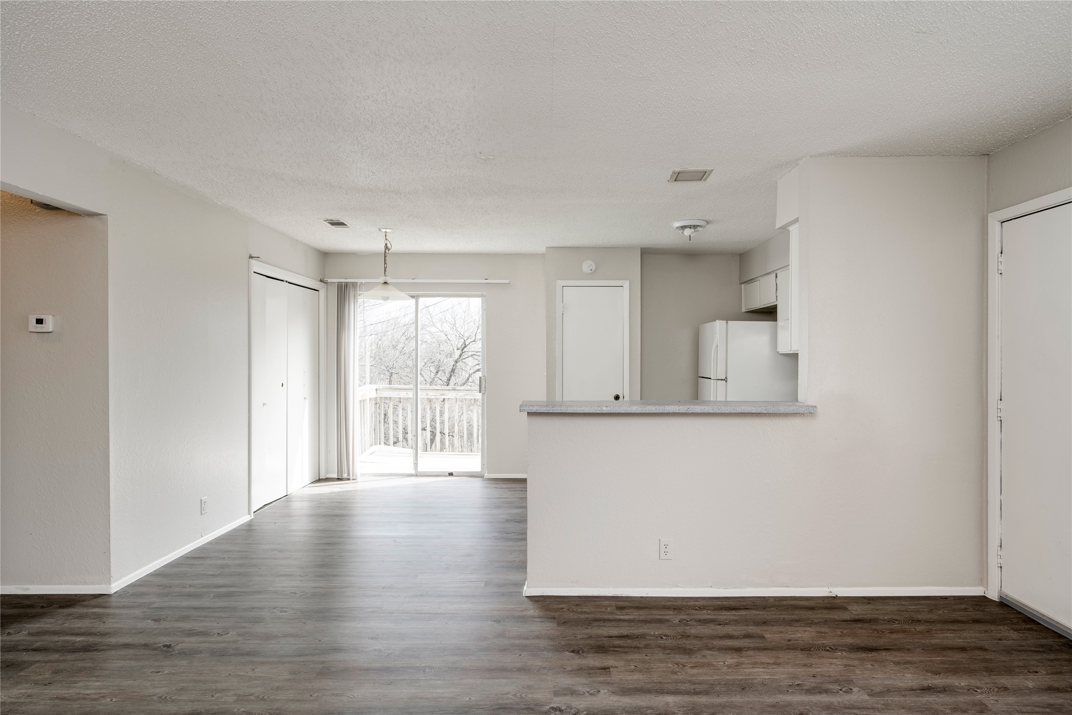 11907 Alpheus Avenue, Unit D Austin, TX 78759 - Photo 4 of 26 a view of an empty room with wooden floor and a window