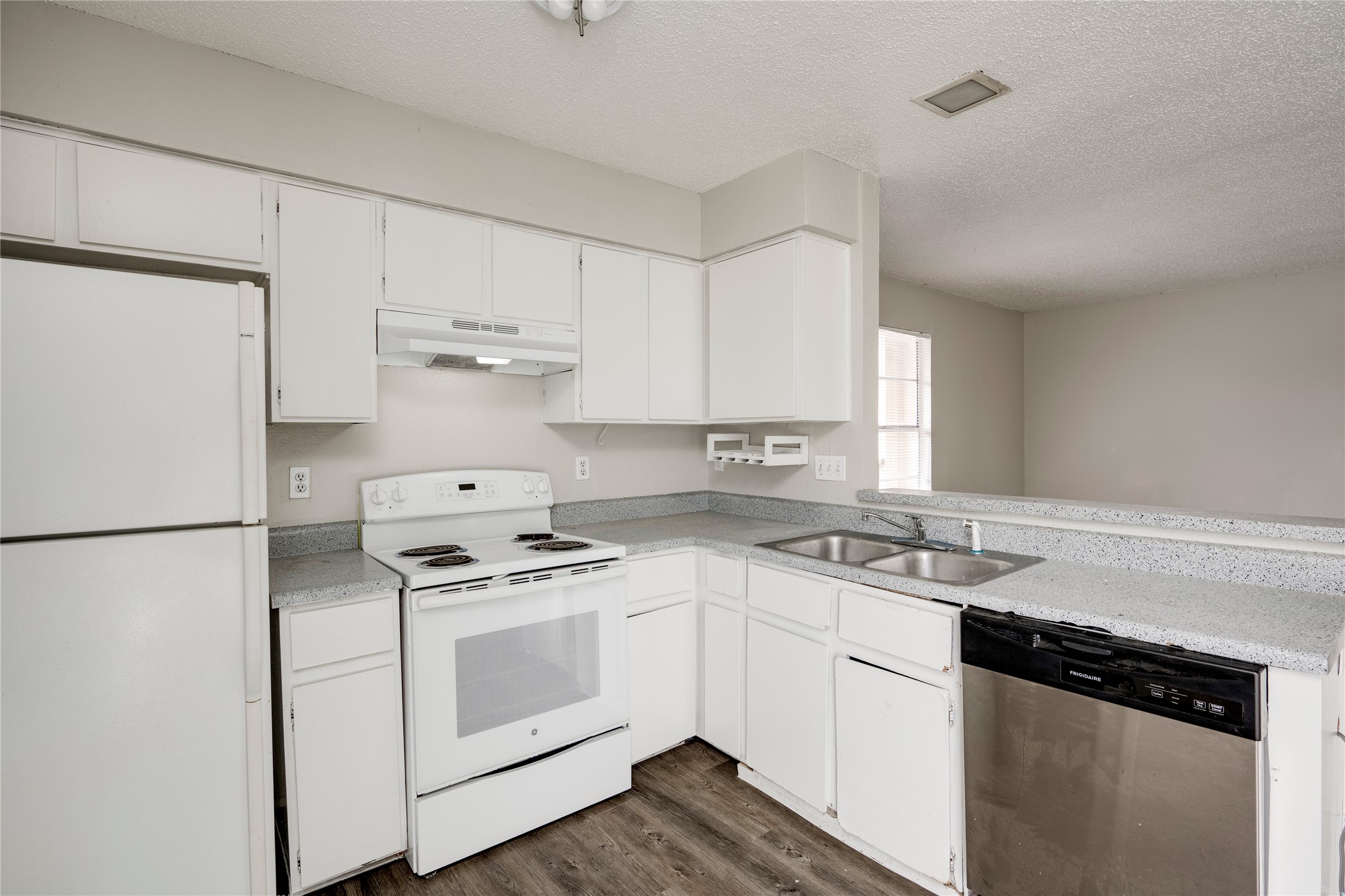 11907 Alpheus Avenue, Unit D Austin, TX 78759 - Photo 9 of 26 a kitchen with cabinets appliances a sink and a window