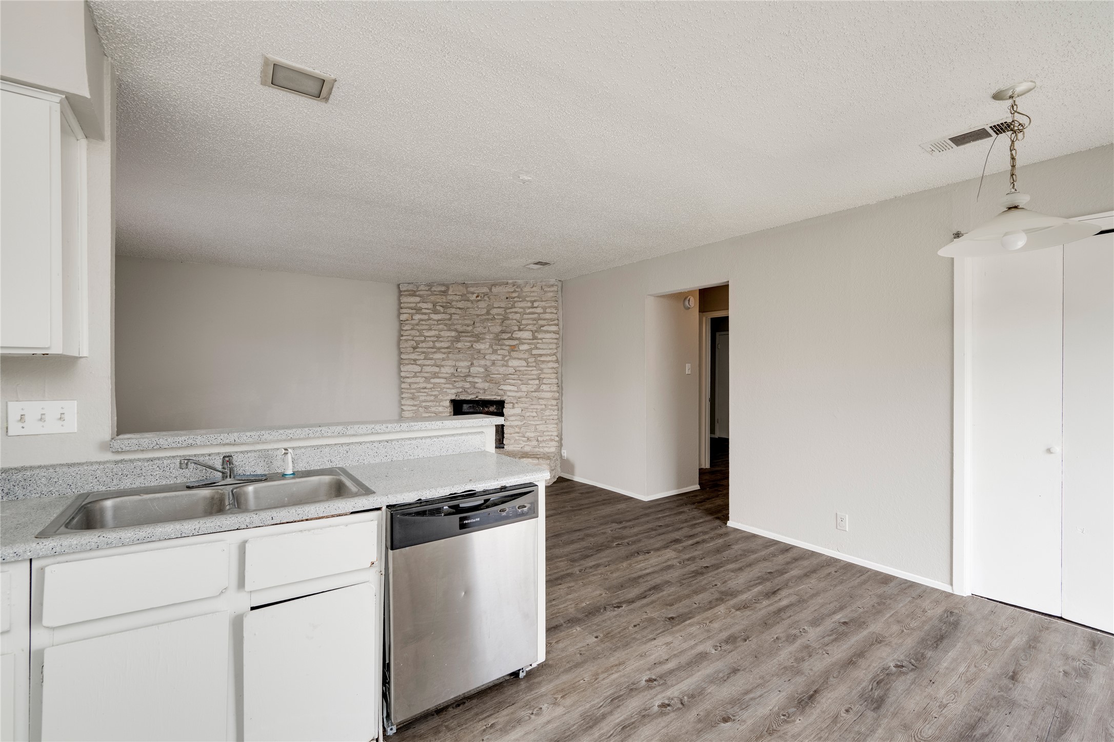 11907 Alpheus Avenue, Unit D Austin, TX 78759 - Photo 10 of 26 a kitchen with sink cabinets and wooden floor