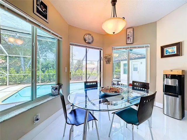 a dining room with furniture a chandelier and window