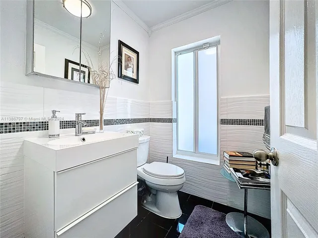 a bathroom with a sink toilet and mirror