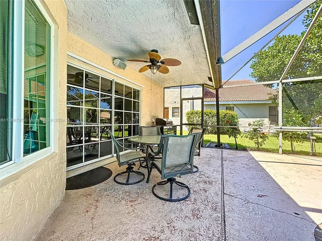 a view of a porch with chairs and backyard