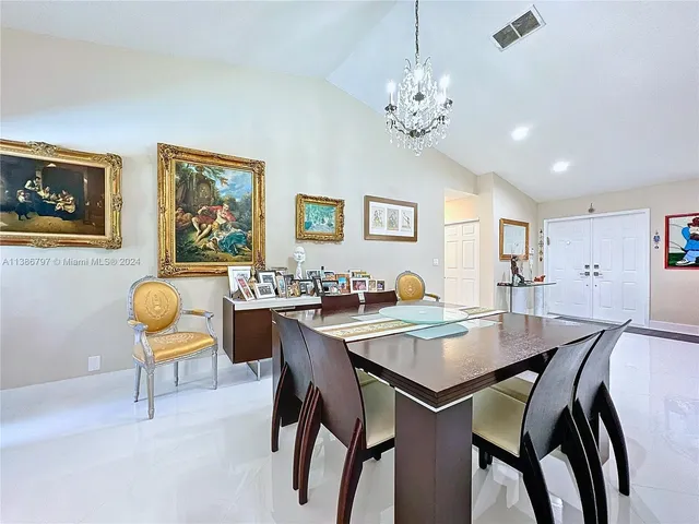 a view of a dining room with furniture and chandelier