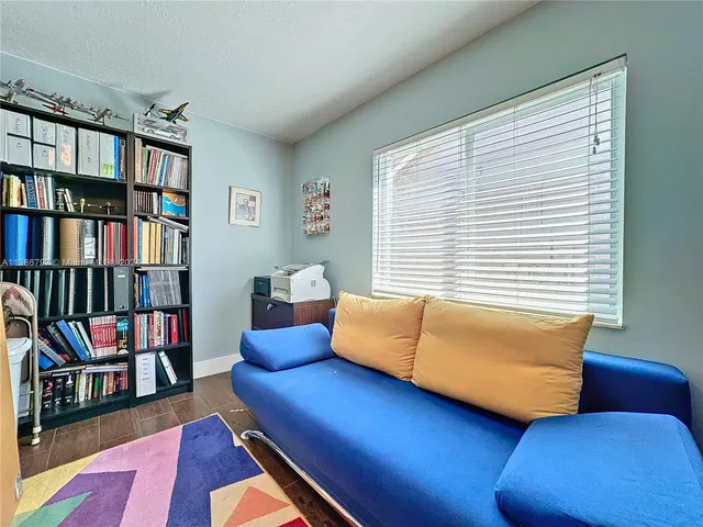 a bedroom with furniture and a book shelf