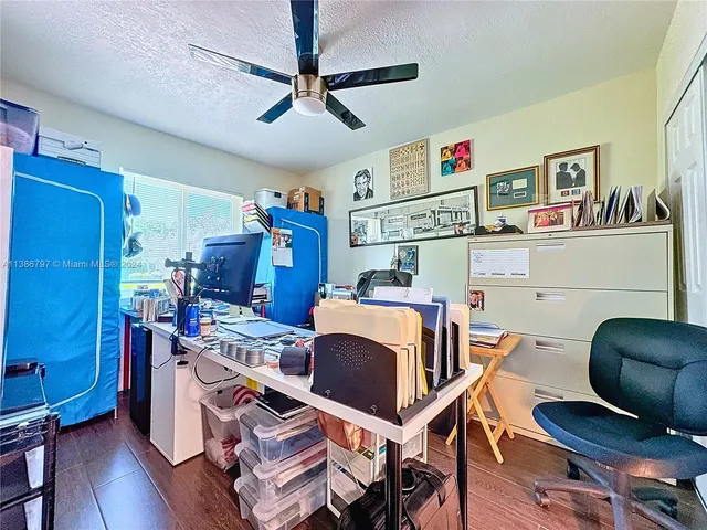 a room with furniture a ceiling fan and a window