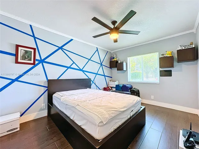 a bedroom with a bed a ceiling fan and a window