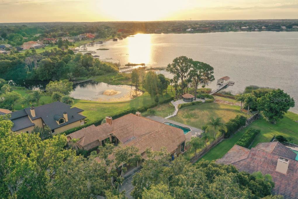 an aerial view of a house with a lake view