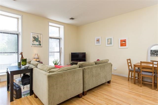 222 Clinton Street, Unit 21 Hoboken, NJ 07030 - Photo 2 of 9 a living room with furniture and a flat screen tv