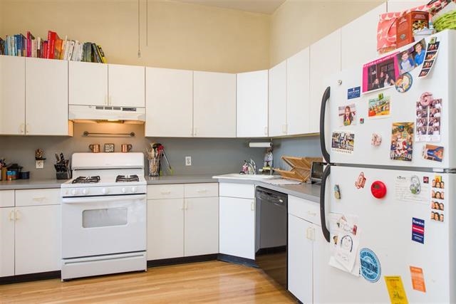 222 Clinton Street, Unit 21 Hoboken, NJ 07030 - Photo 3 of 9 a kitchen with a white stove top oven and white refrigerator