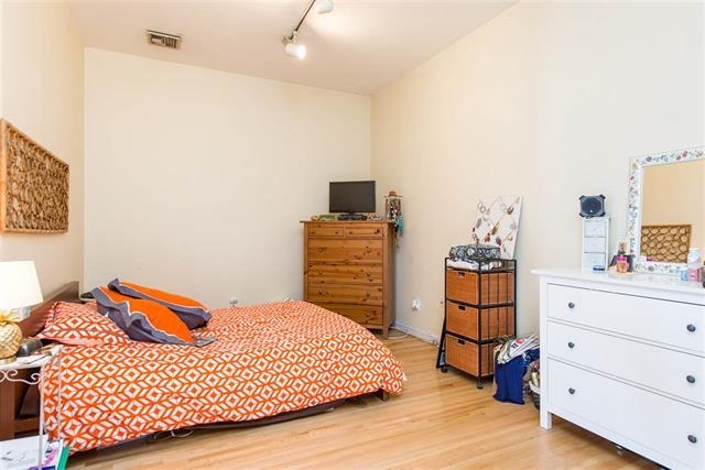 222 Clinton Street, Unit 21 Hoboken, NJ 07030 - Photo 5 of 9 a bedroom with a bed and dresser