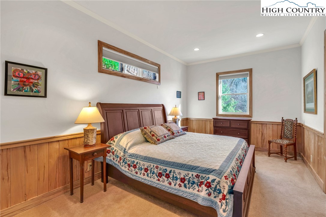 933 Thunder Ridge Lane Lenoir, NC 28645 - Photo 33 of 45 a bedroom with a bed a table and painting on the wall