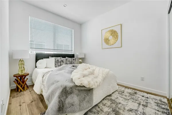 a bedroom with a bed and painting on the wall