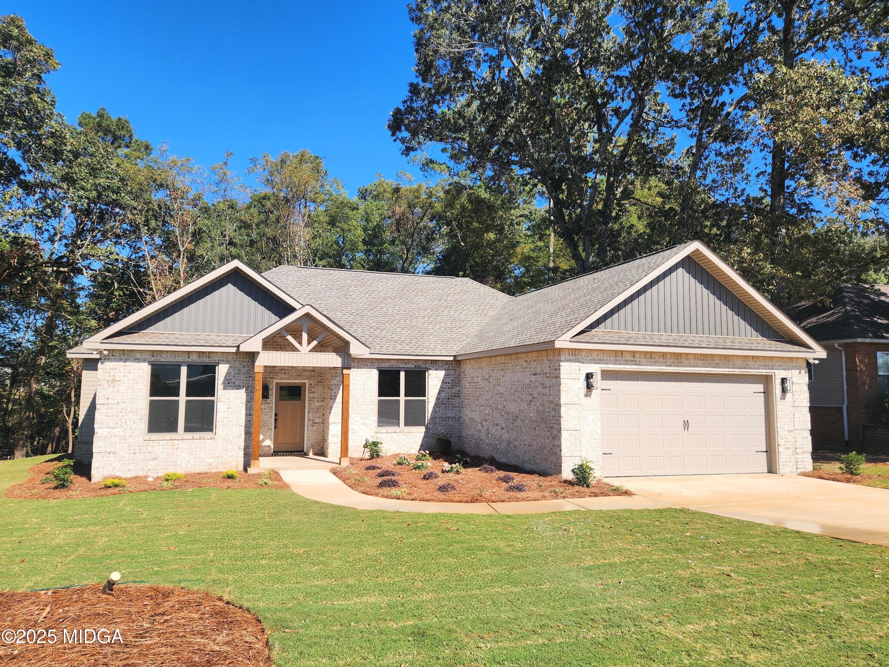 404 Minter Drive Warner Robins, GA 31088 - Photo 1 of 60 a front view of a house with a garden and yard