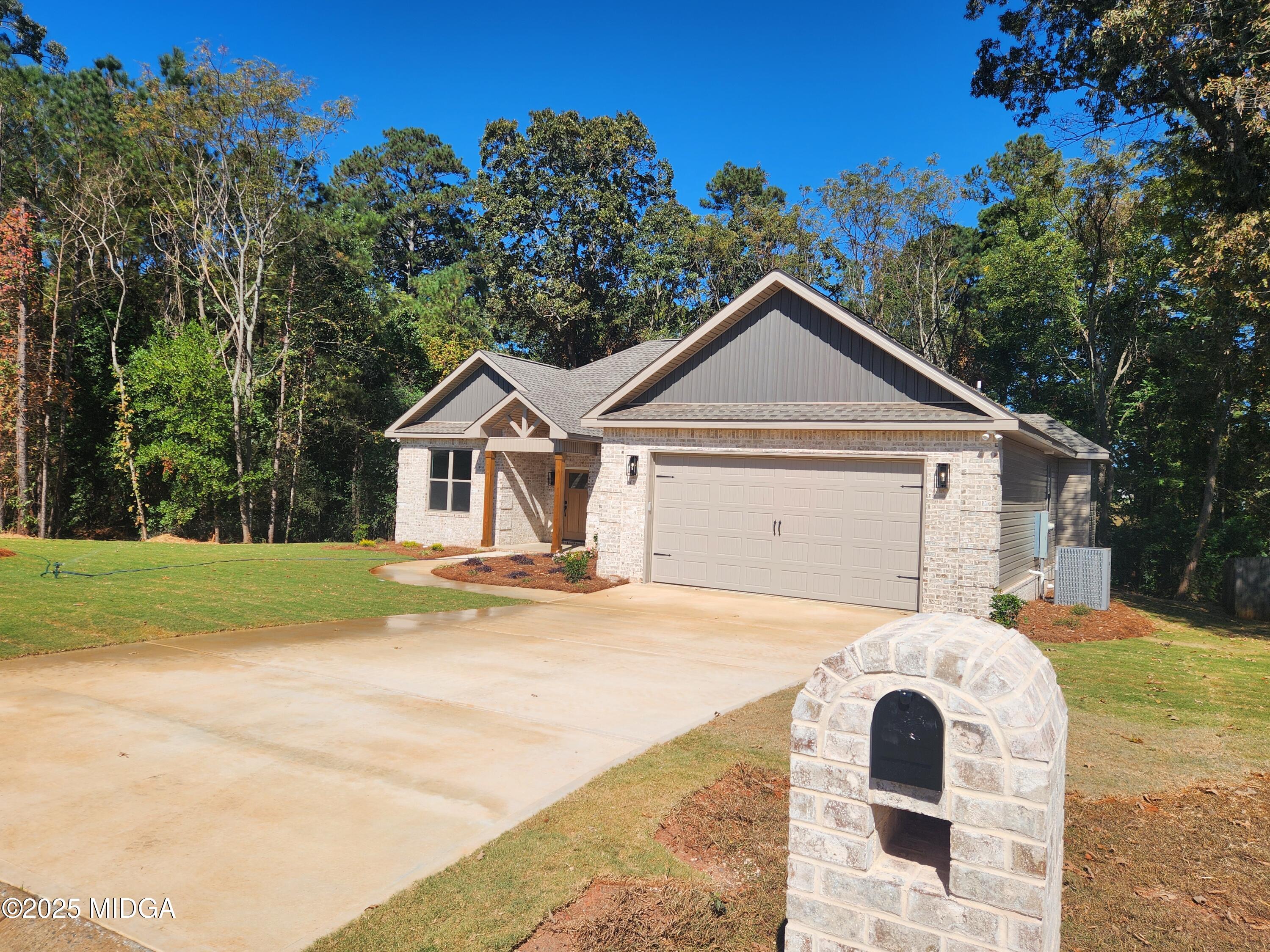 404 Minter Drive Warner Robins, GA 31088 - Photo 11 of 60 a front view of a house with a yard and garage