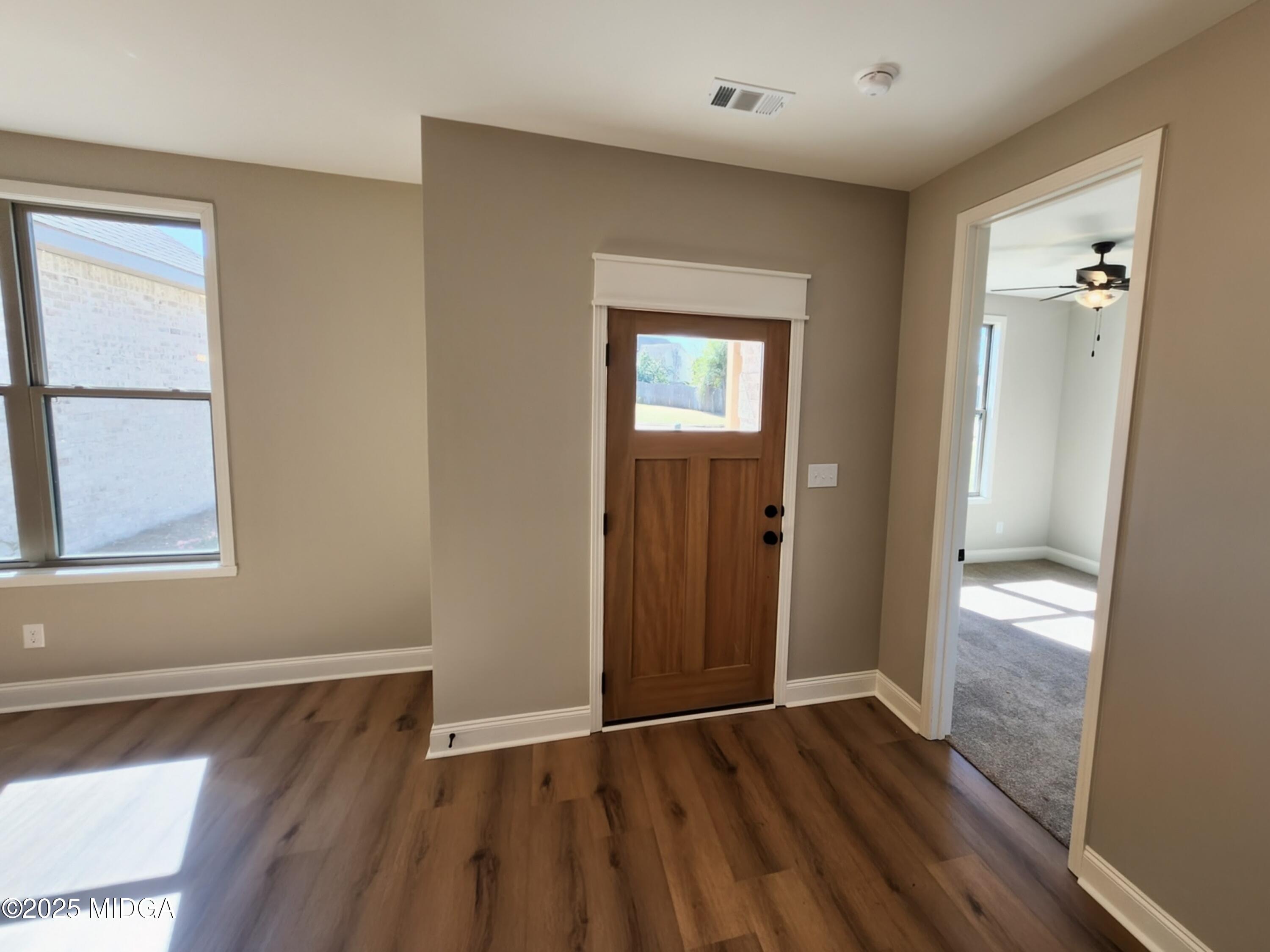 404 Minter Drive Warner Robins, GA 31088 - Photo 16 of 60 an empty room with wooden floor and windows