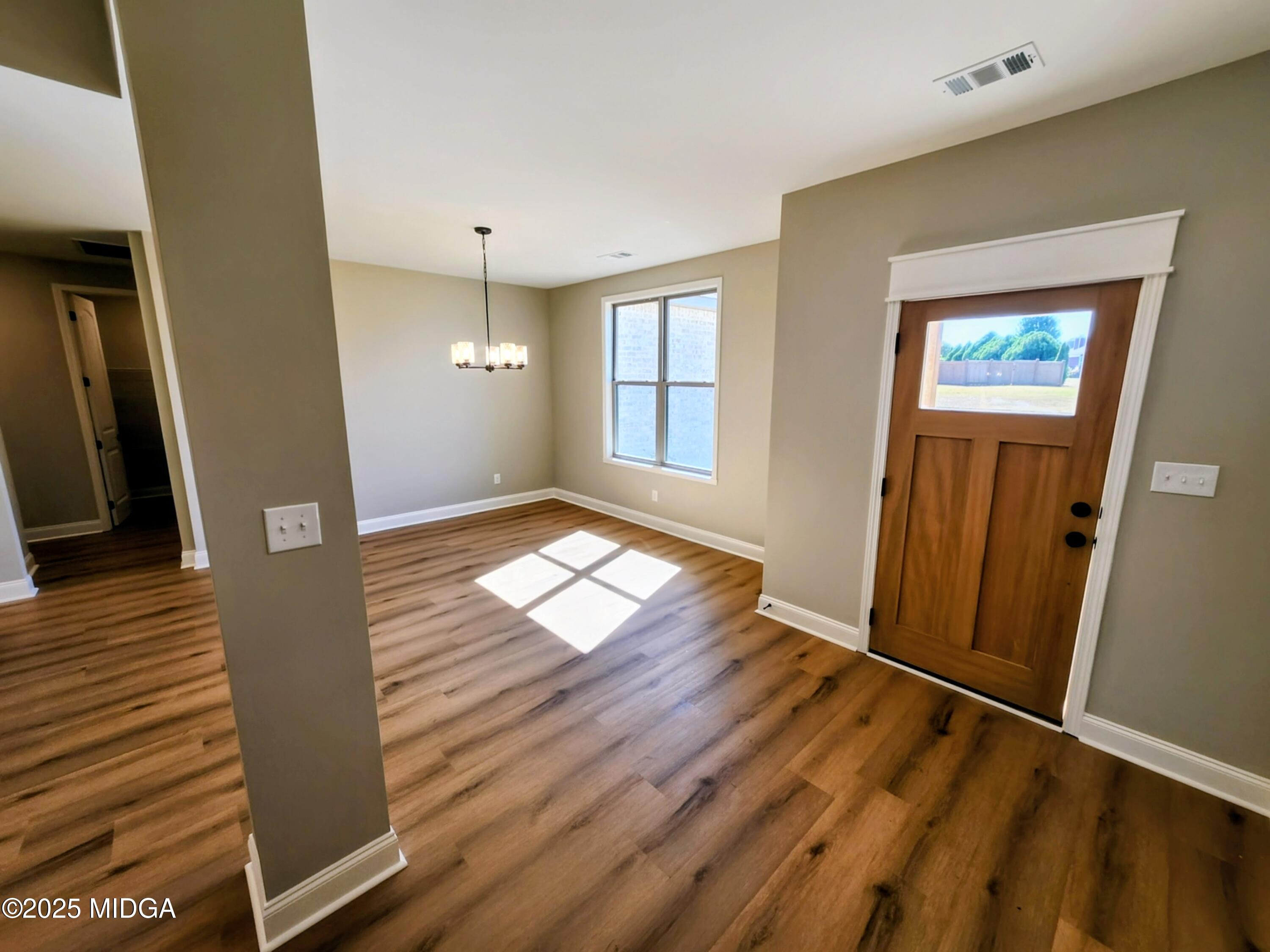 404 Minter Drive Warner Robins, GA 31088 - Photo 17 of 60 wooden floor in an empty room with a window