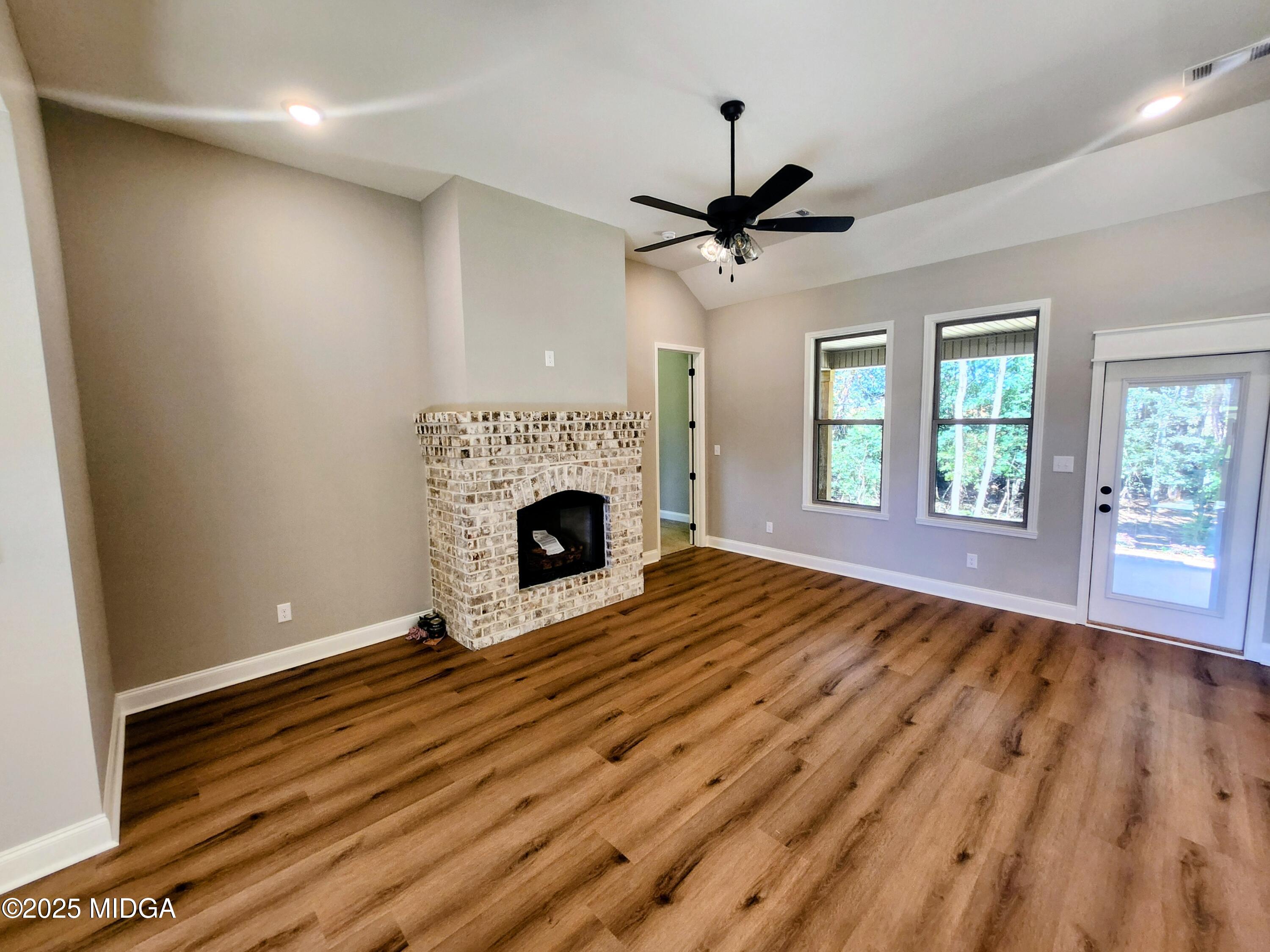 404 Minter Drive Warner Robins, GA 31088 - Photo 18 of 60 wooden floor in an empty room with a fireplace