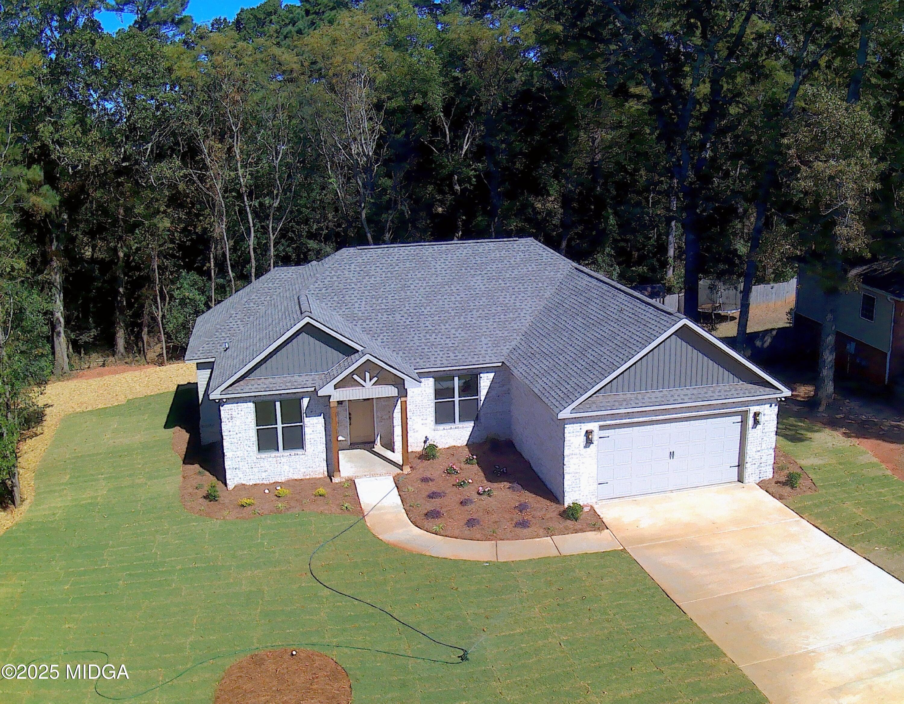 404 Minter Drive Warner Robins, GA 31088 - Photo 2 of 60 a house with green field in front of it