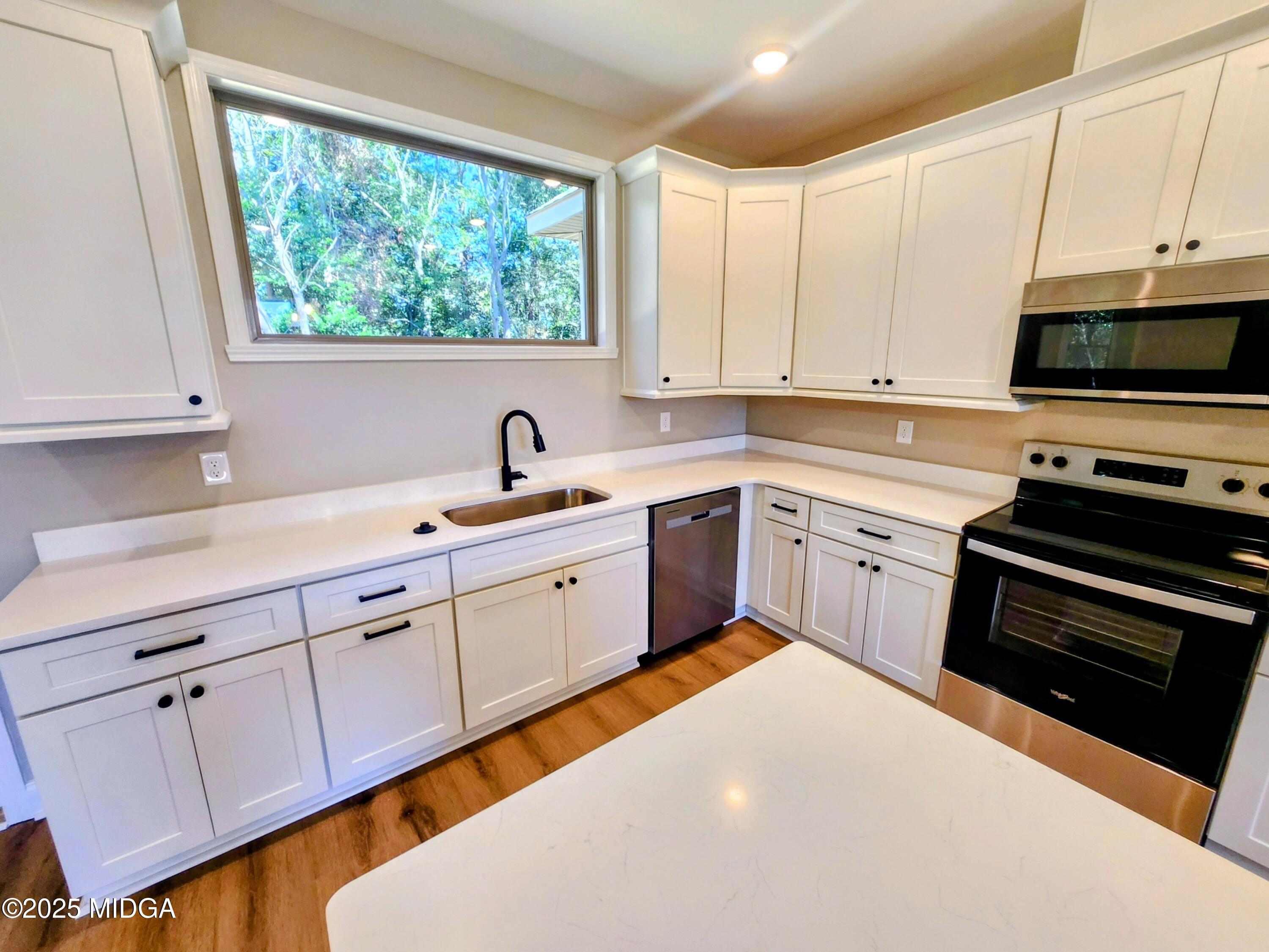 404 Minter Drive Warner Robins, GA 31088 - Photo 23 of 60 a kitchen with a sink stove and cabinets