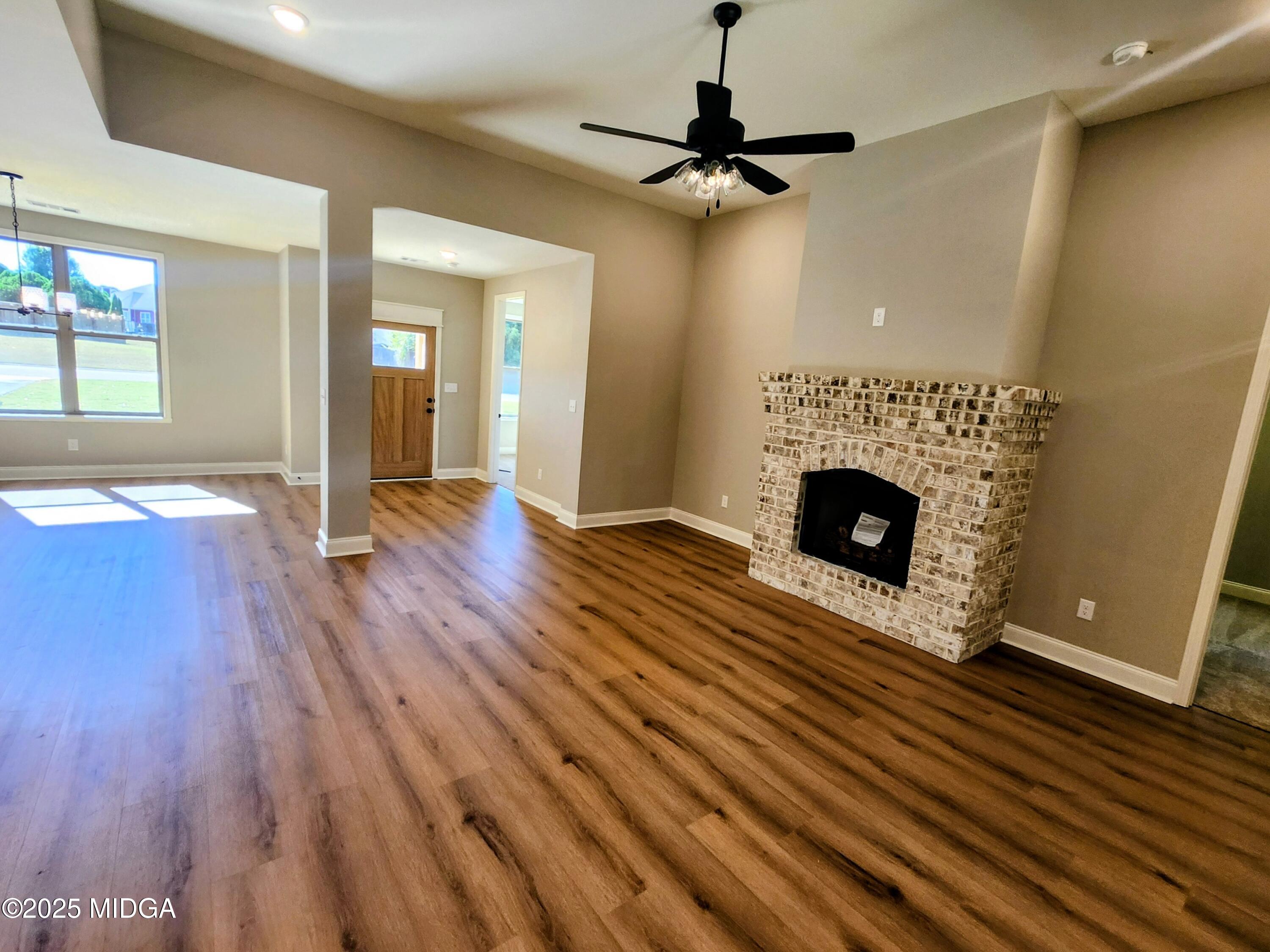 404 Minter Drive Warner Robins, GA 31088 - Photo 25 of 60 a view of an empty room with wooden floor a fireplace and a window