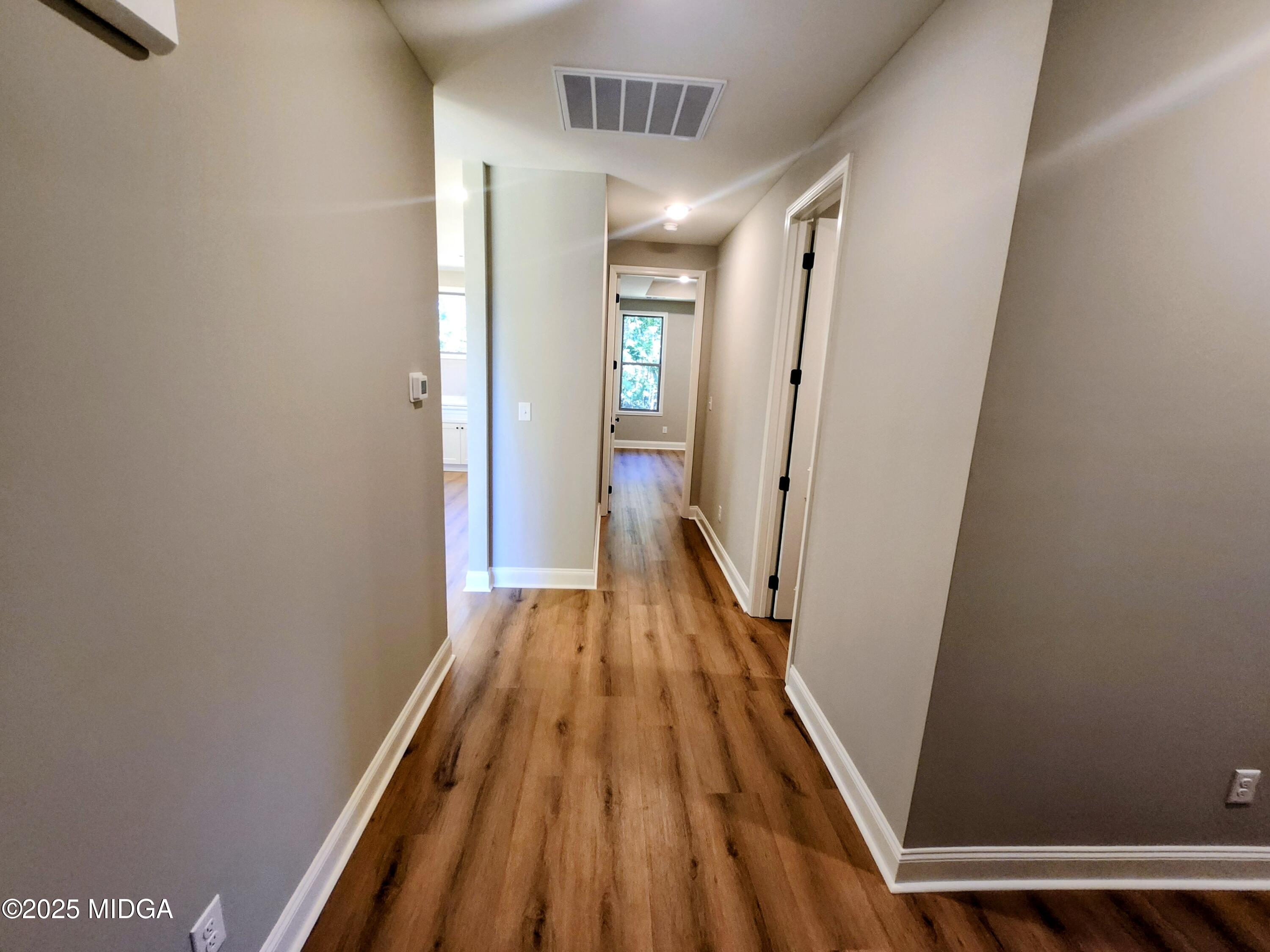 404 Minter Drive Warner Robins, GA 31088 - Photo 27 of 60 a view of a hallway with wooden floor and staircase